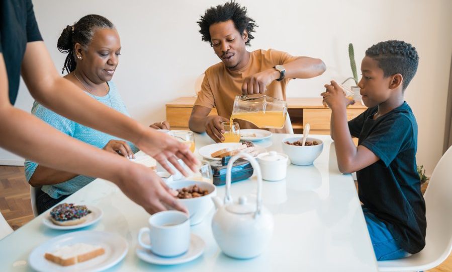 Family having breakfast together at home.