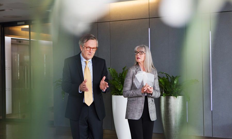 Businessman and businesswoman having discussion while walking