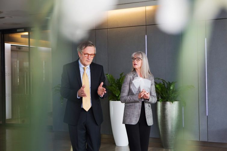 Businessman and businesswoman having discussion while walking