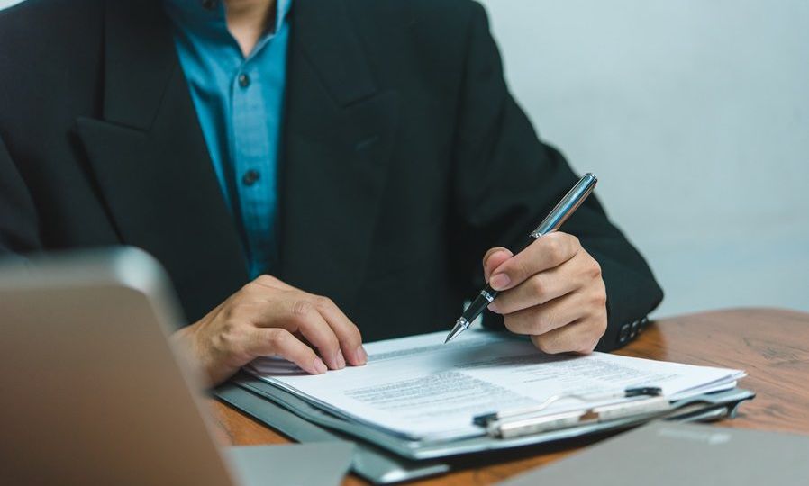 businessman agree to make deal signing document, sale contract, employment job or legal transaction contract at desk