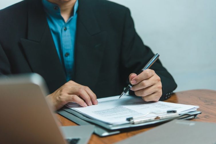 businessman agree to make deal signing document, sale contract, employment job or legal transaction contract at desk